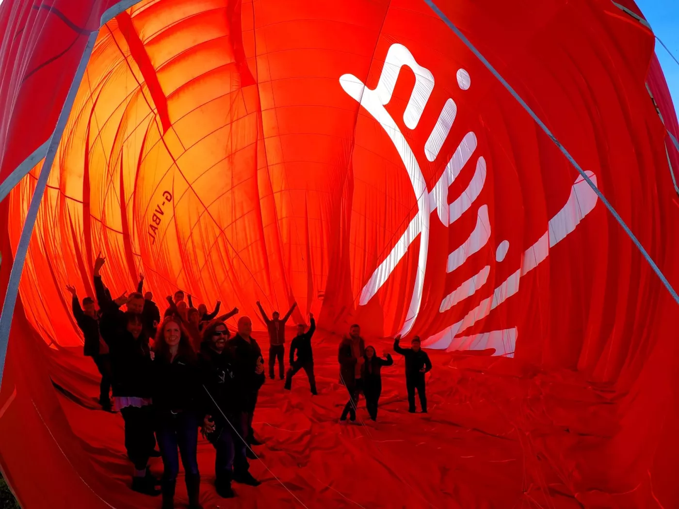 Passengers standing inside a hot air balloon before deflating